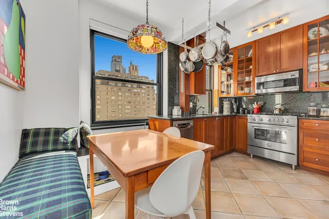a kitchen with a table chairs and a chandelier