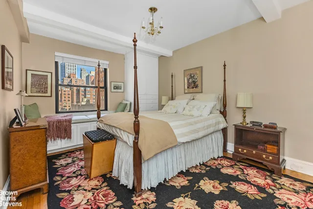 a spacious bedroom with a bed and wooden floor