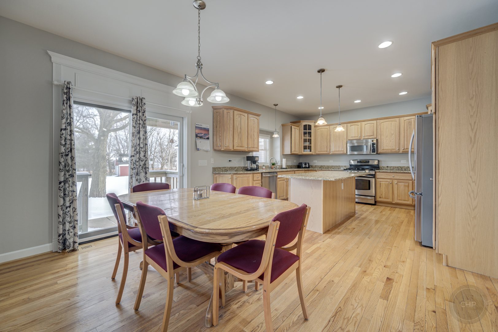 5S263 Middle Road Naperville, IL 60563 - Photo 12 of 46 a view of a dining room and livingroom with furniture wooden floor a chandelier
