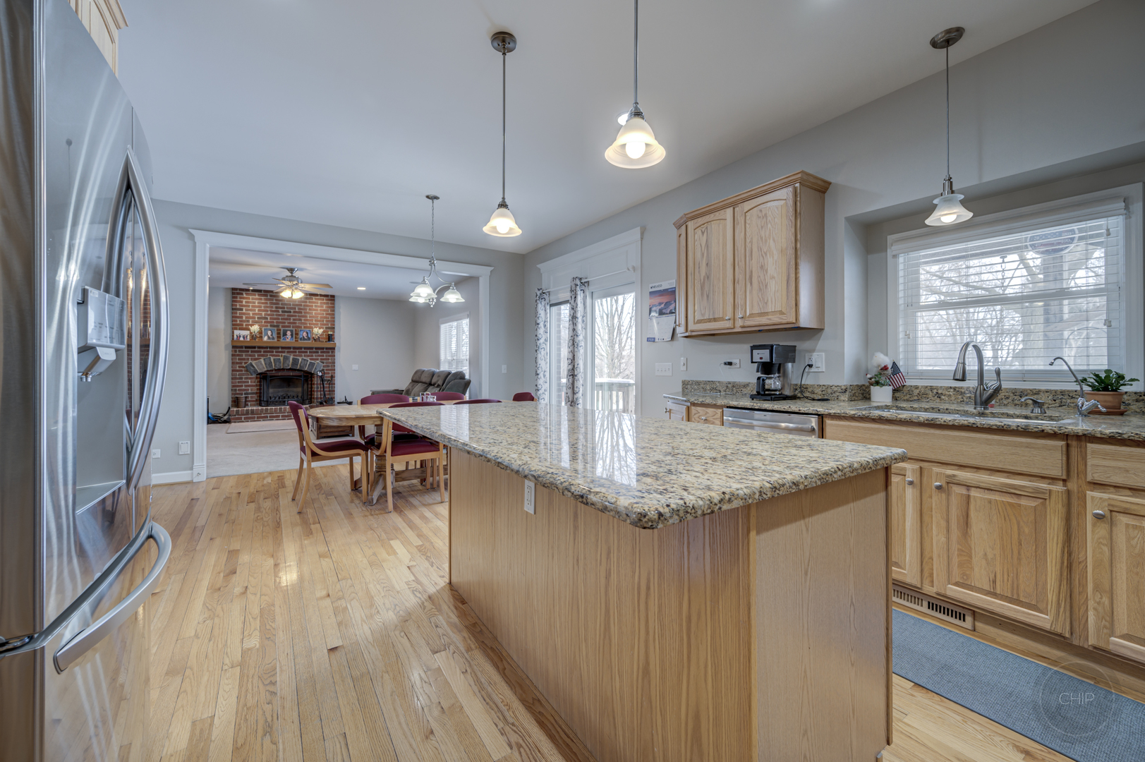 5S263 Middle Road Naperville, IL 60563 - Photo 14 of 46 a kitchen with stainless steel appliances granite countertop sink stove refrigerator dining table and chairs