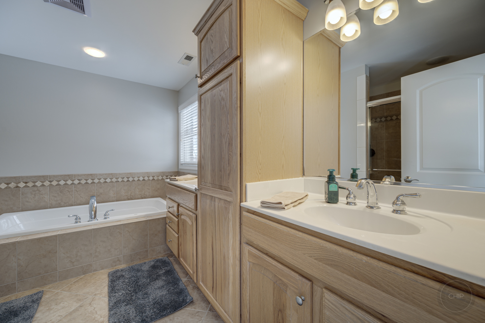 5S263 Middle Road Naperville, IL 60563 - Photo 22 of 46 a bathroom with a tub sink and mirror
