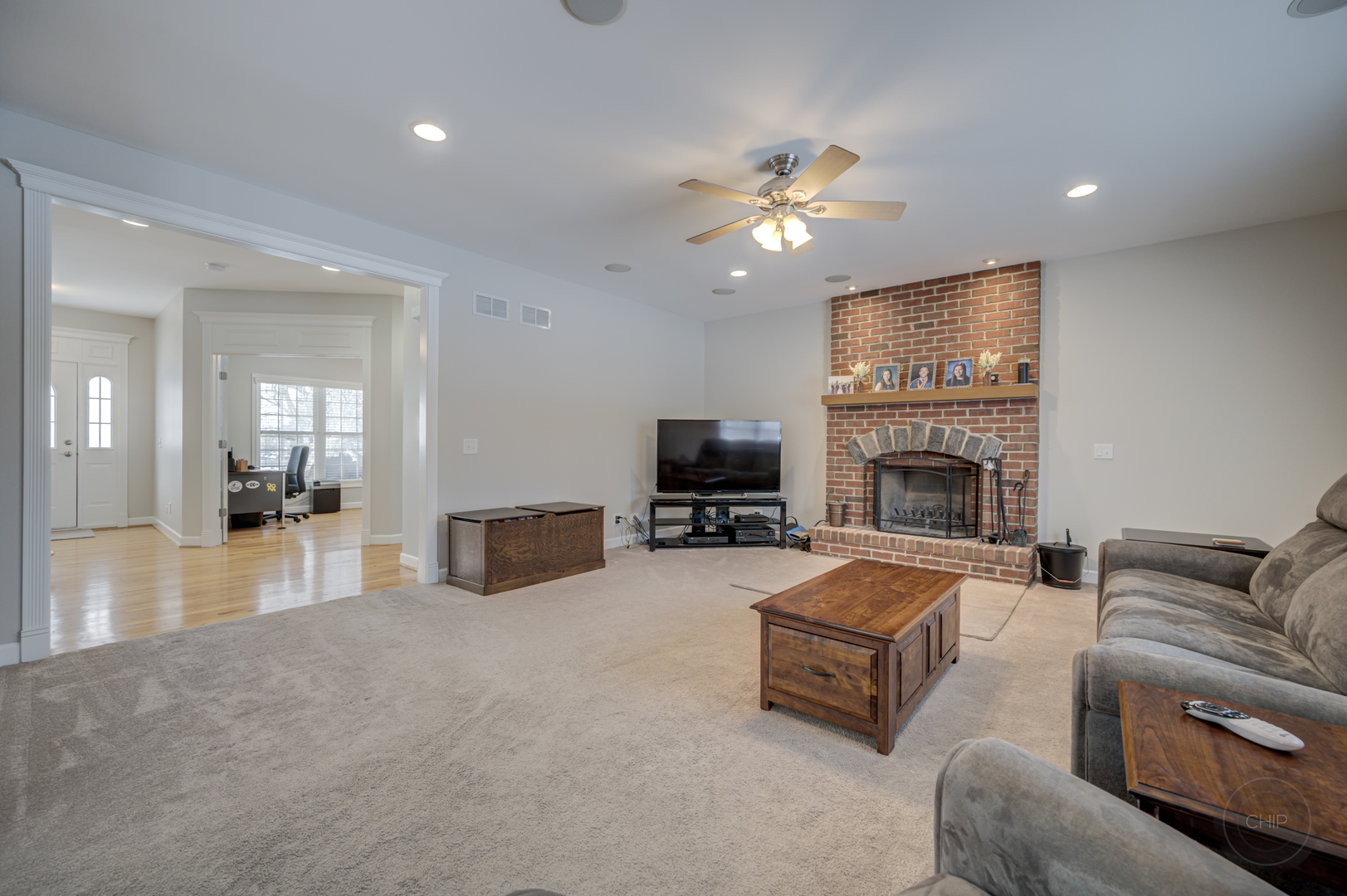 5S263 Middle Road Naperville, IL 60563 - Photo 10 of 46 a living room with furniture a fireplace and a flat screen tv