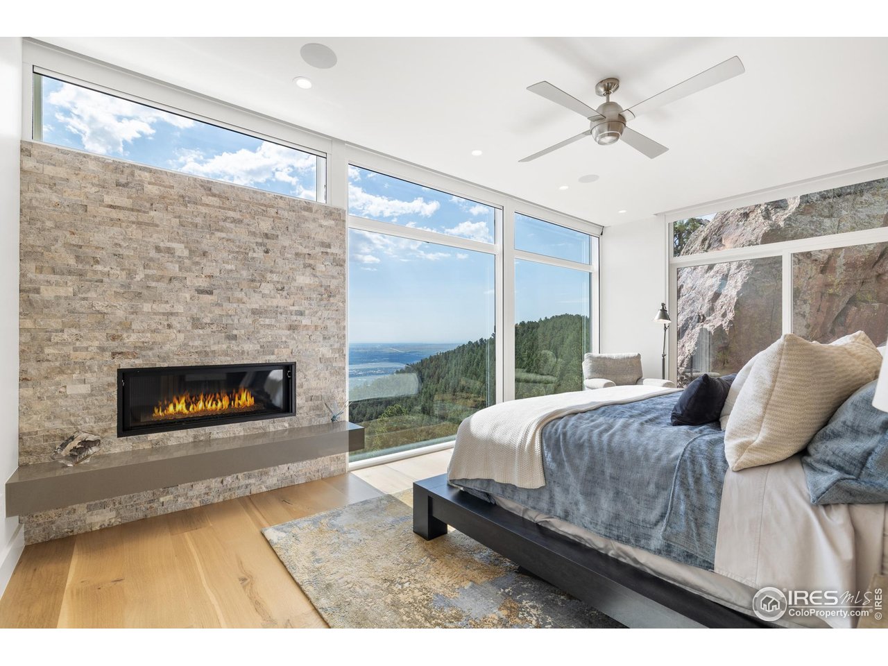 1145 Timber Lane Boulder, CO 80304 - Photo 12 of 40 a living room with a bed furniture a fireplace and a large window