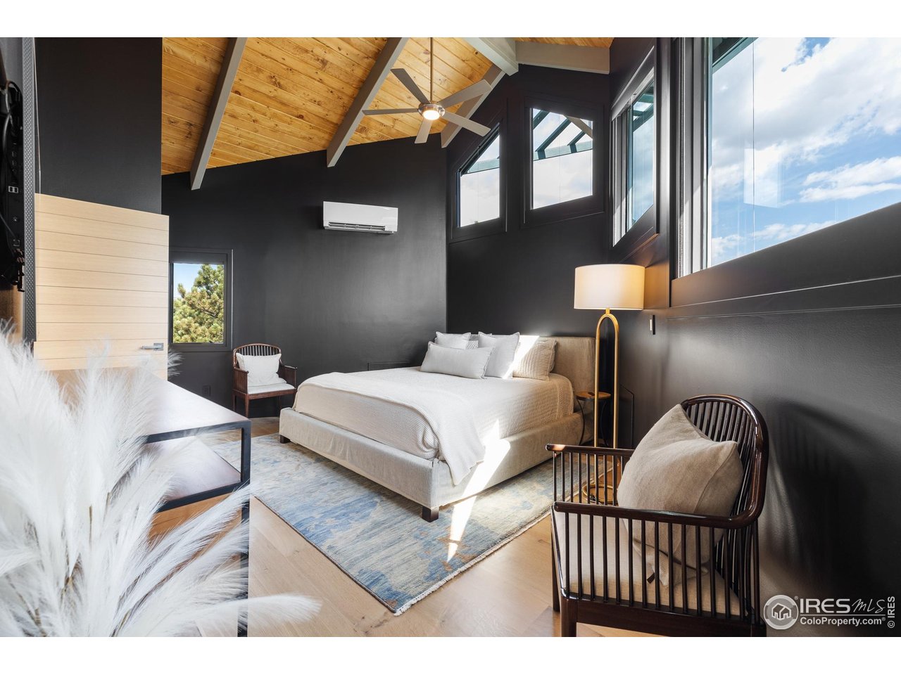 1145 Timber Lane Boulder, CO 80304 - Photo 21 of 40 a bedroom with a bed lamp and a large window with the outer view