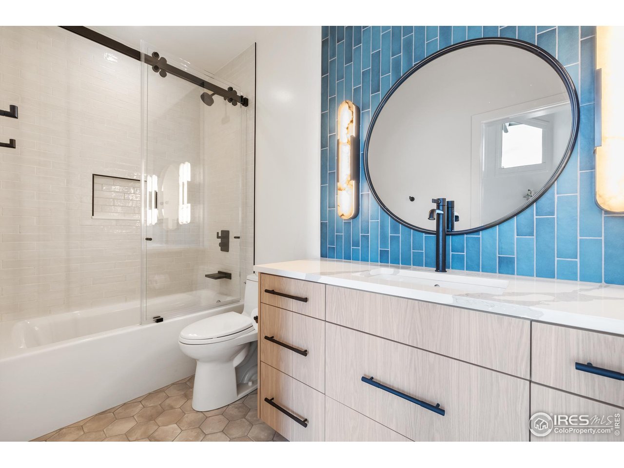 1145 Timber Lane Boulder, CO 80304 - Photo 24 of 40 a bathroom with a sink a toilet and a mirror