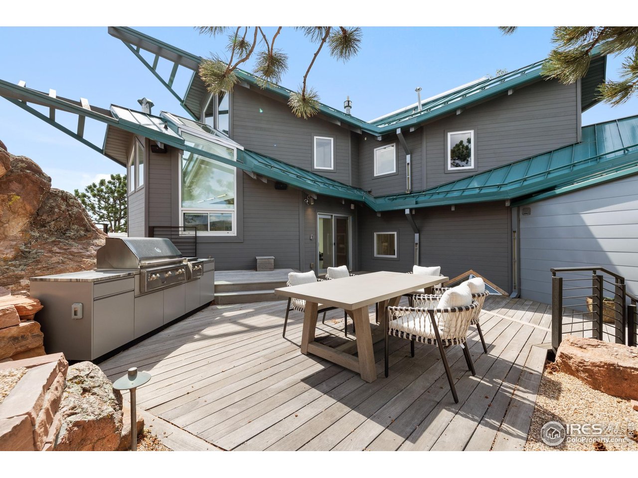 1145 Timber Lane Boulder, CO 80304 - Photo 31 of 40 a backyard of a house with barbeque oven table and chairs