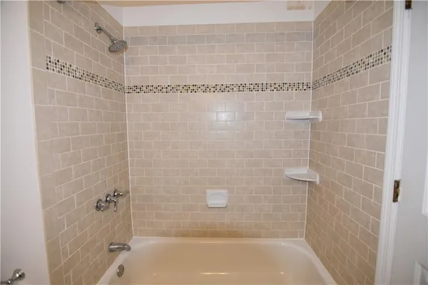 a bathroom with a shower and a bathtub
