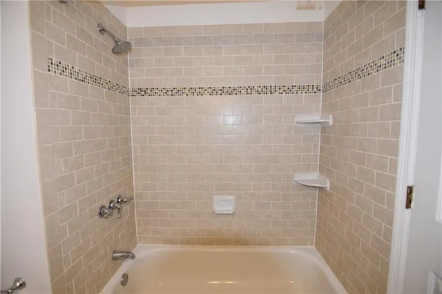 a bathroom with a shower and a bathtub