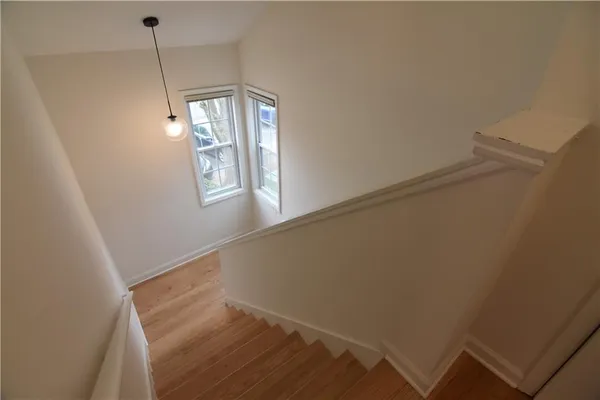 a view of hallway with window and stairs