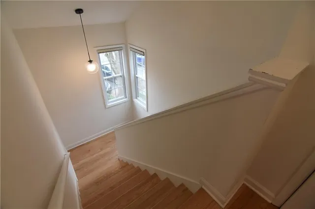 a view of hallway with window and stairs