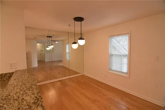 a view of an empty room with a chandelier fan