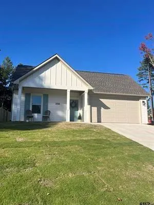 a view of a house with a garden and yard
