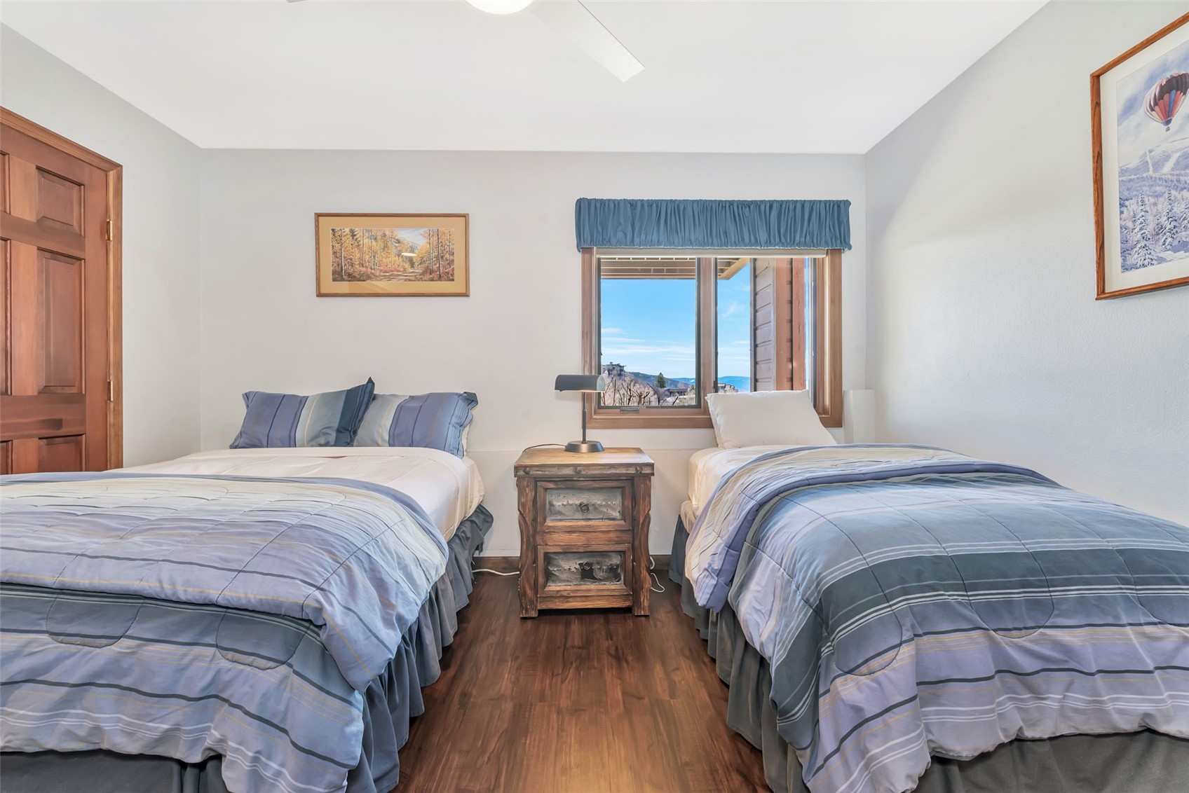 1720 Ranch Road, Unit 309 Steamboat Springs, CO 80487 - Photo 23 of 43 a bedroom with two beds and a chandelier