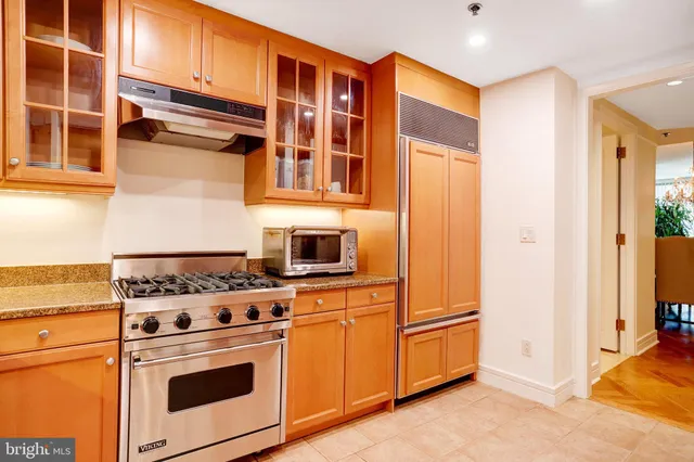 a view of a livingroom with wooden floor and furniture