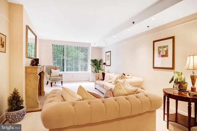 a living room with furniture and large windows