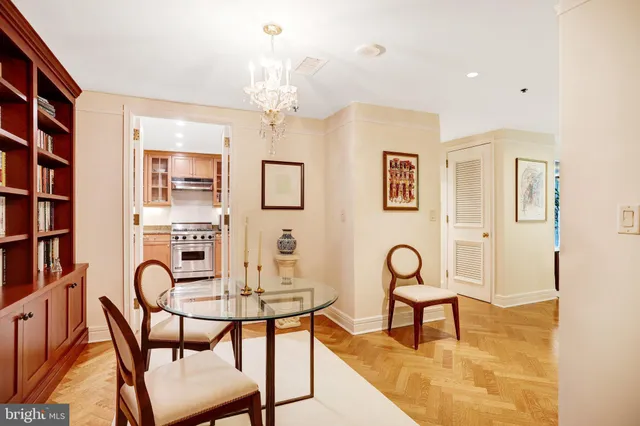 a front view of a livingroom with chairs and entryway