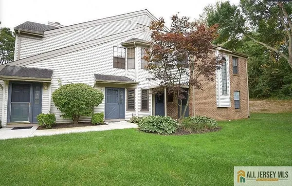 a view of a house with a yard and plants