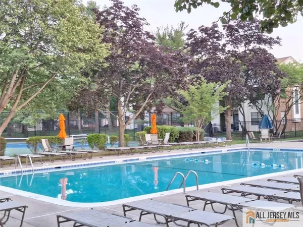 a view of swimming pool with outdoor seating and plants