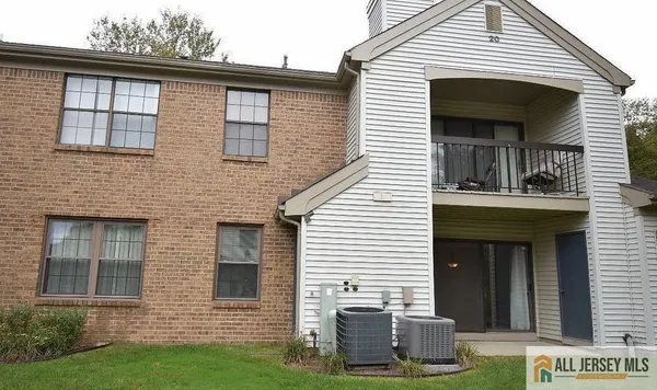 a view of a house with a yard and large windows