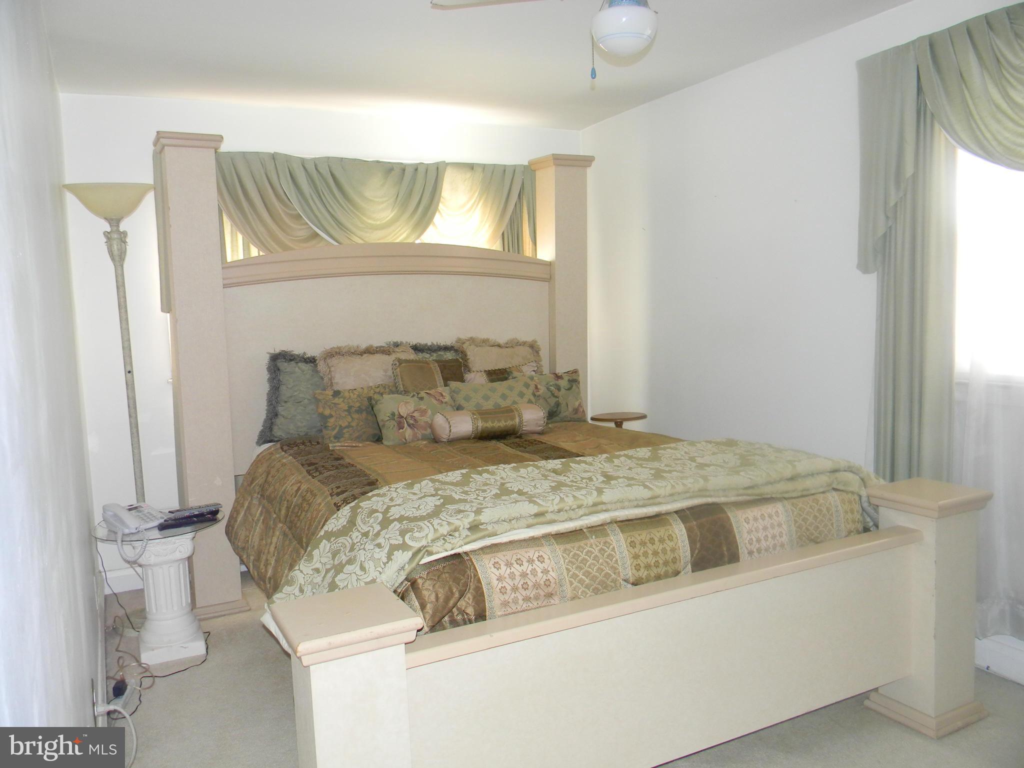 1515 Clairidge Road Baltimore, MD 21207 - Photo 14 of 21 a bed sitting in a bedroom next to a window
