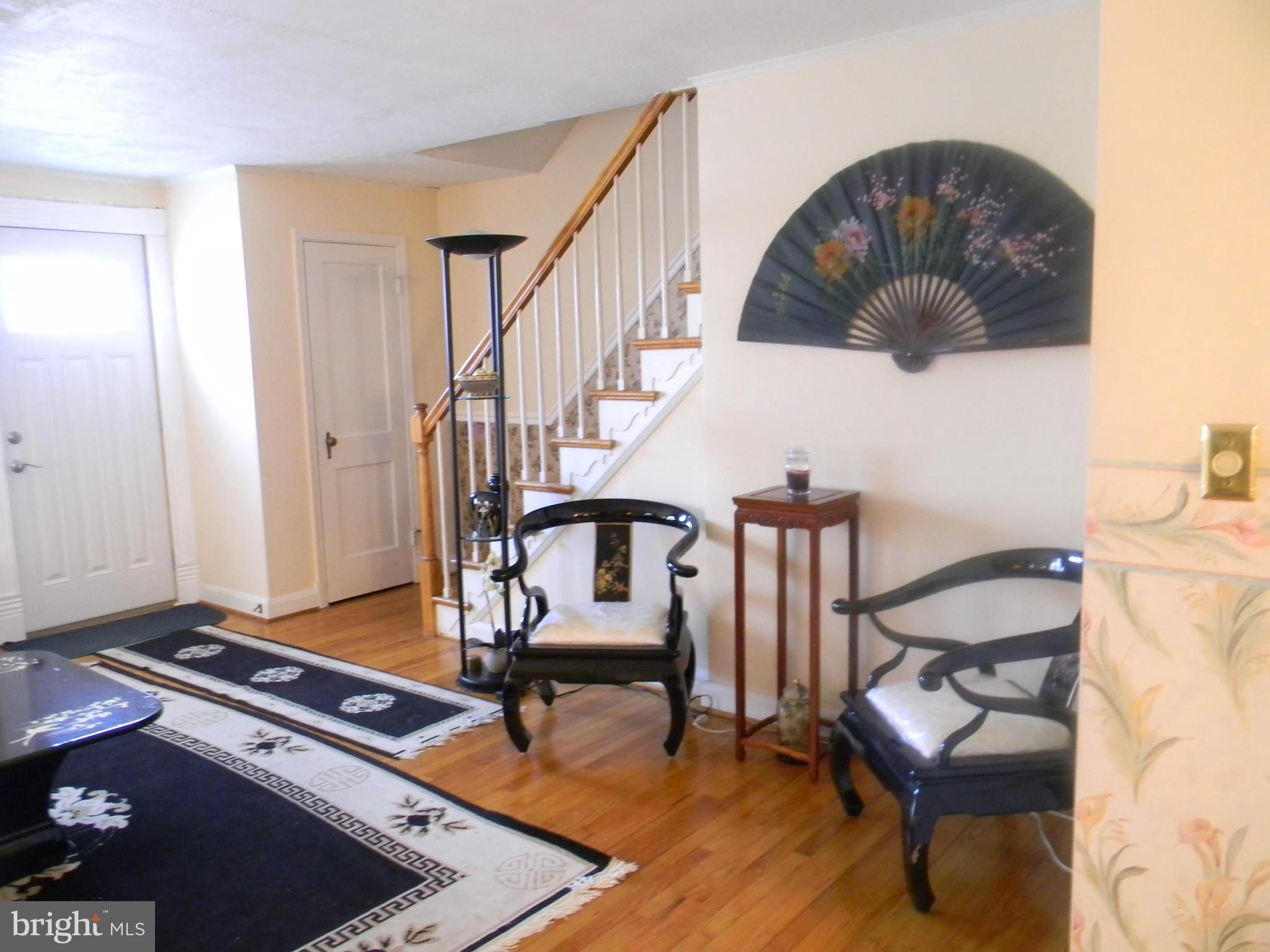 1515 Clairidge Road Baltimore, MD 21207 - Photo 3 of 21 a living room with furniture and wooden floor