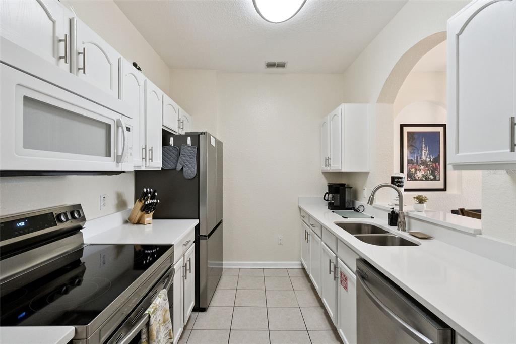 2809 Almaton Loop, Unit 401 Kissimmee, FL 34747 - Photo 11 of 59 a kitchen with a sink stove and microwave
