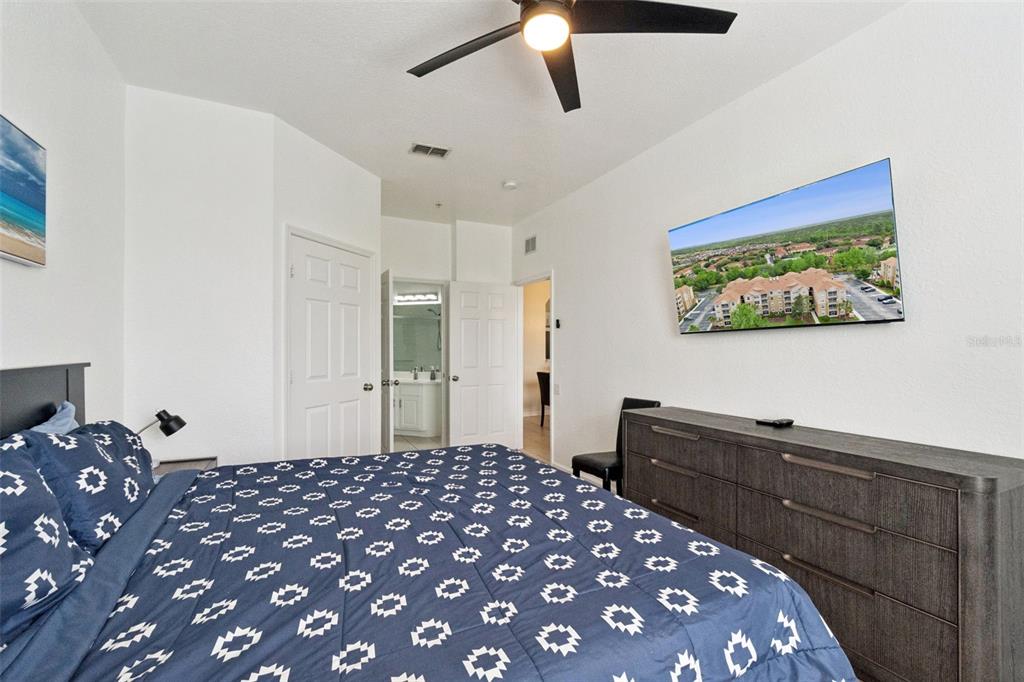 2809 Almaton Loop, Unit 401 Kissimmee, FL 34747 - Photo 12 of 59 a bedroom with a bed and cabinets