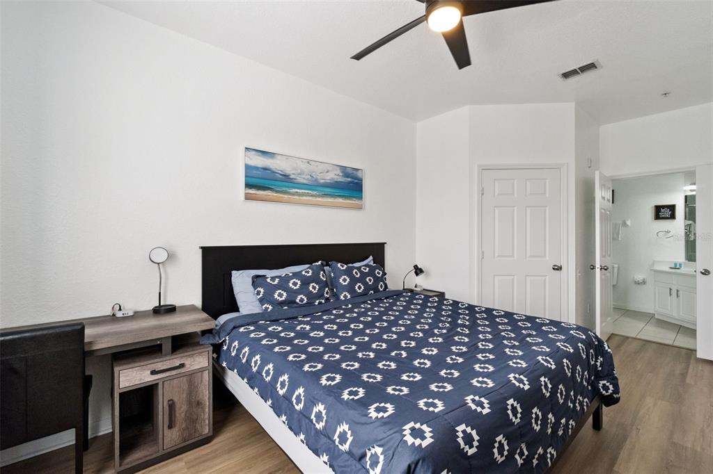 2809 Almaton Loop, Unit 401 Kissimmee, FL 34747 - Photo 13 of 59 a bedroom with a bed and a chandelier