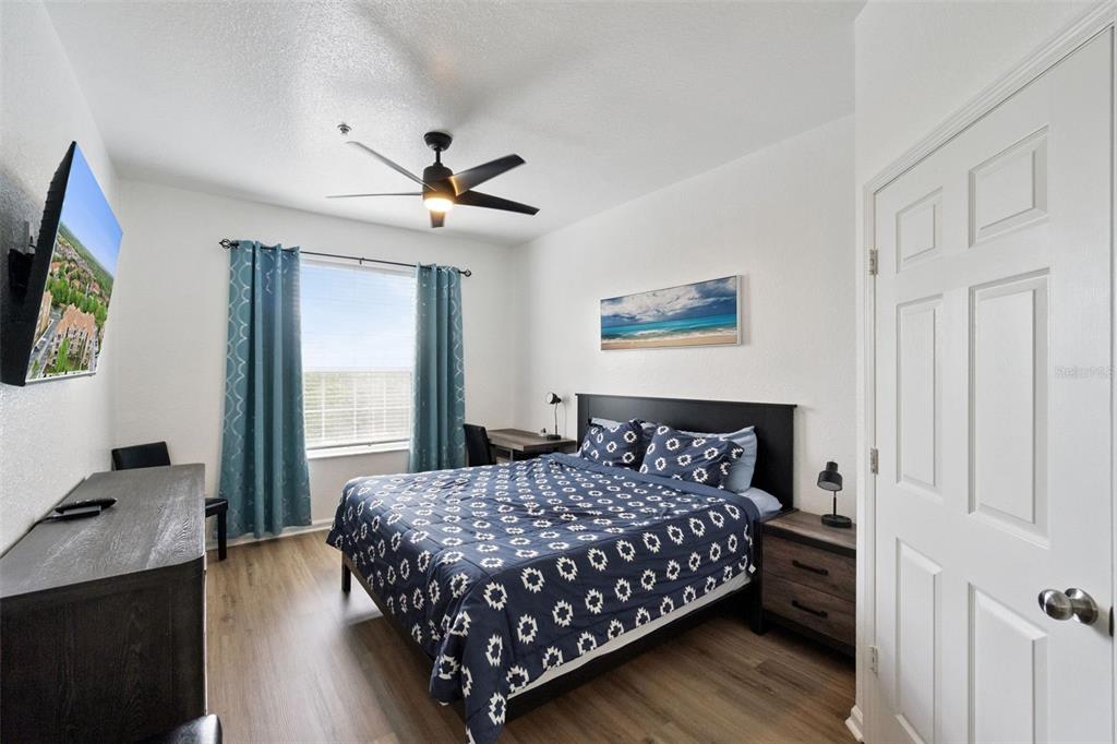 2809 Almaton Loop, Unit 401 Kissimmee, FL 34747 - Photo 14 of 59 a bedroom with a bed and a flat screen tv