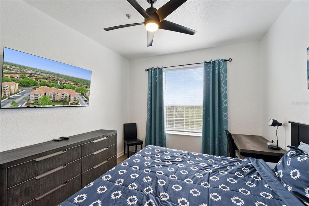 2809 Almaton Loop, Unit 401 Kissimmee, FL 34747 - Photo 15 of 59 a bedroom with a bed and a desk