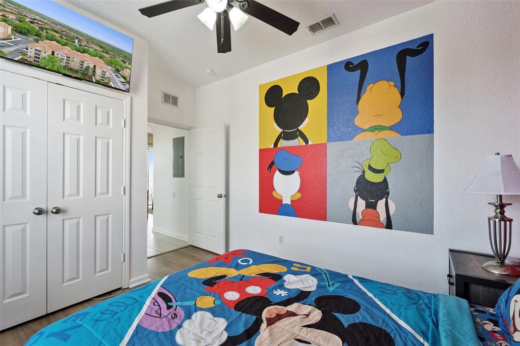 2809 Almaton Loop, Unit 401 Kissimmee, FL 34747 - Photo 17 of 59 a bedroom with a bed a window and painting on the wall