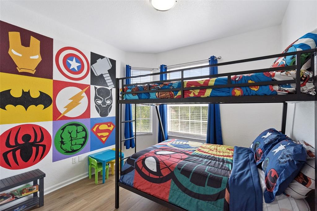 2809 Almaton Loop, Unit 401 Kissimmee, FL 34747 - Photo 19 of 59 a bedroom with a bed and dresser with wooden floor