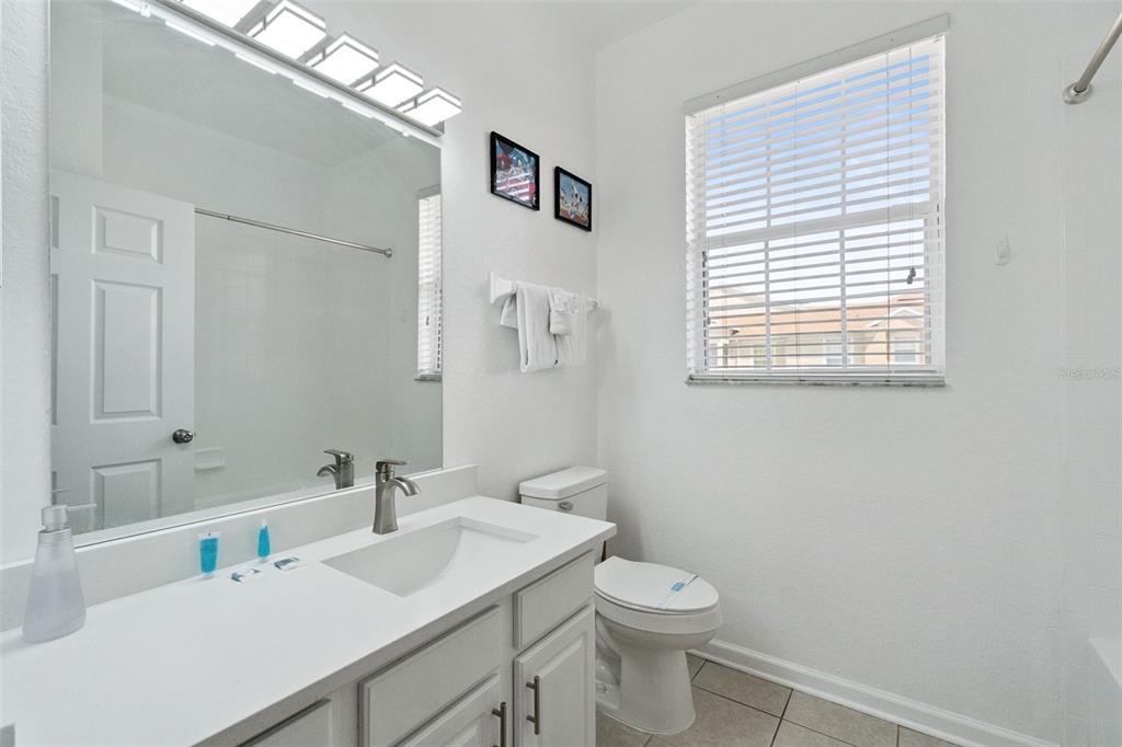 2809 Almaton Loop, Unit 401 Kissimmee, FL 34747 - Photo 20 of 59 a bathroom with a sink and a toilet
