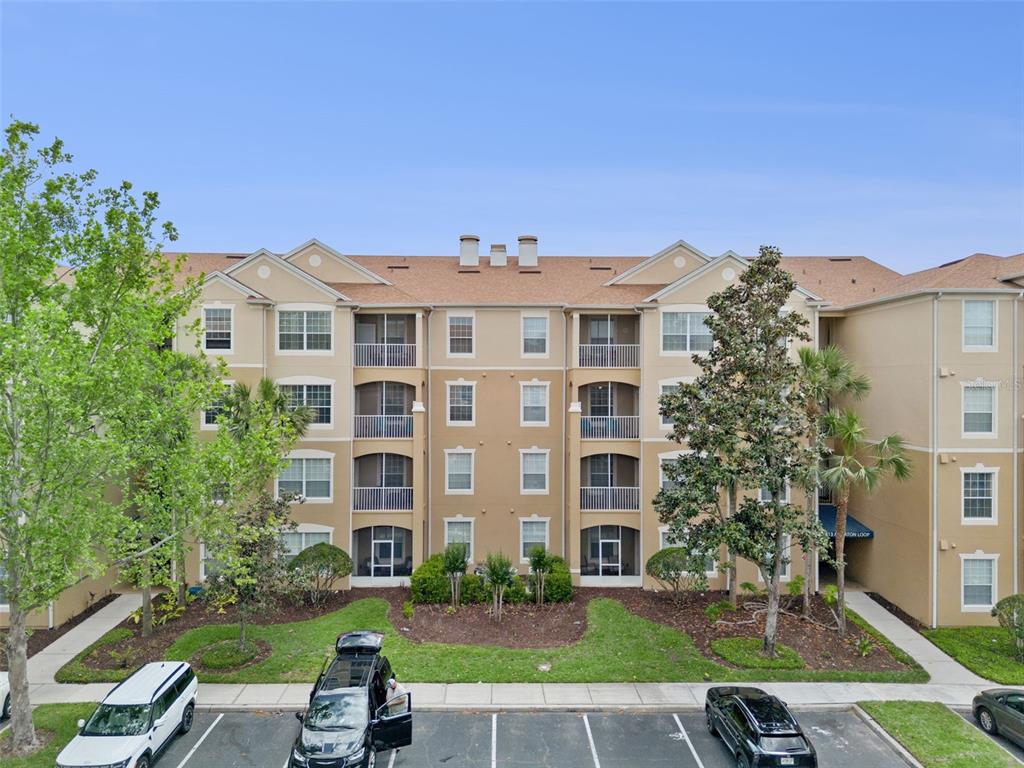 2809 Almaton Loop, Unit 401 Kissimmee, FL 34747 - Photo 2 of 59 a front view of a building with garden
