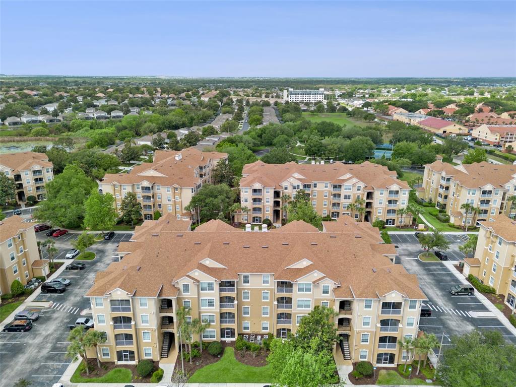 2809 Almaton Loop, Unit 401 Kissimmee, FL 34747 - Photo 27 of 59 an aerial view of multiple houses with a city view