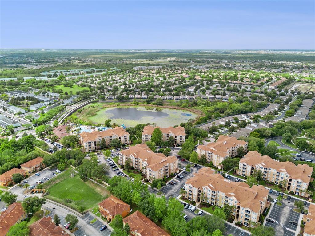 2809 Almaton Loop, Unit 401 Kissimmee, FL 34747 - Photo 28 of 59 an aerial view of residential houses with outdoor space and river