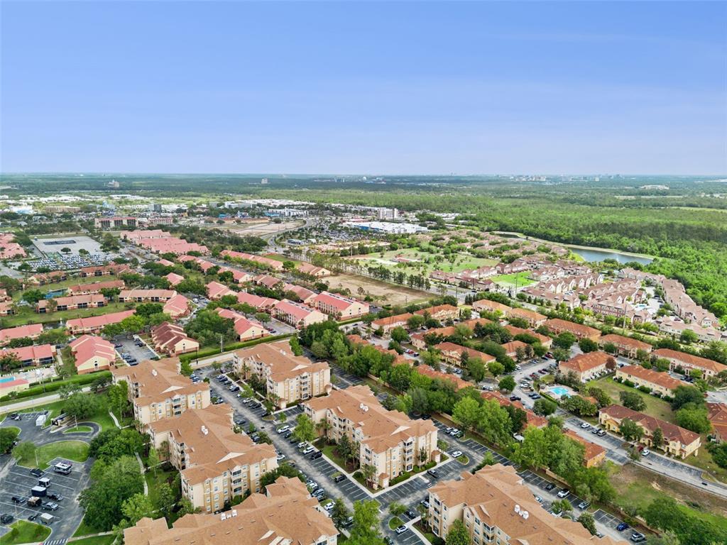 2809 Almaton Loop, Unit 401 Kissimmee, FL 34747 - Photo 33 of 59 an aerial view of residential houses with outdoor space and trees