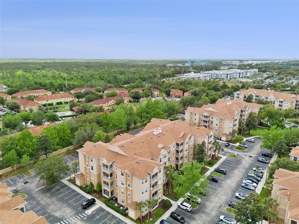 2809 Almaton Loop, Unit 401 Kissimmee, FL 34747 - Photo 35 of 59 an aerial view of residential houses with outdoor space and trees