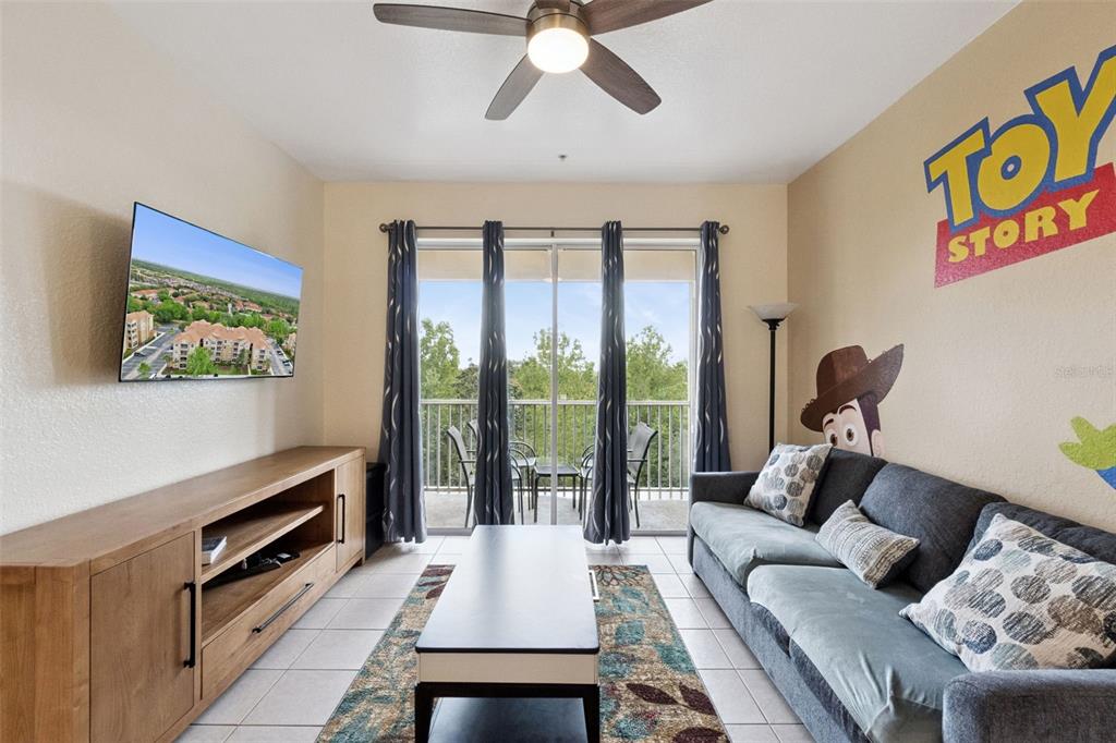 2809 Almaton Loop, Unit 401 Kissimmee, FL 34747 - Photo 5 of 59 a living room with furniture and a flat screen tv