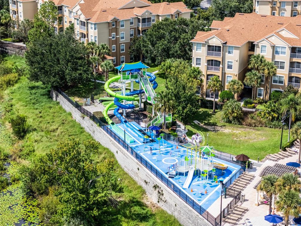 2809 Almaton Loop, Unit 401 Kissimmee, FL 34747 - Photo 57 of 59 an aerial view of a house with a garden and swimming pool