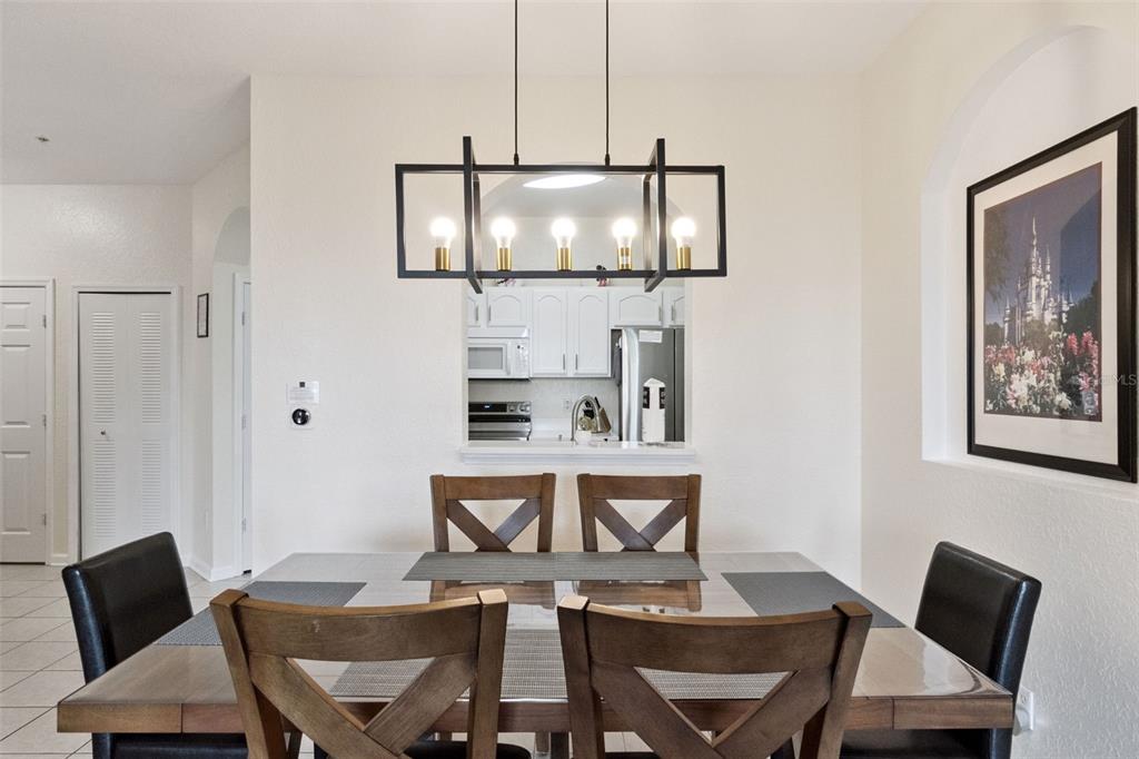 2809 Almaton Loop, Unit 401 Kissimmee, FL 34747 - Photo 8 of 59 a view of a dining room with furniture and wooden floor