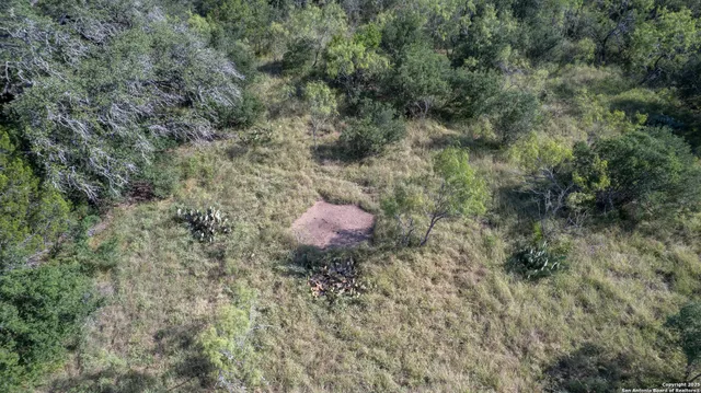 a view of a golf course with yellow lighting