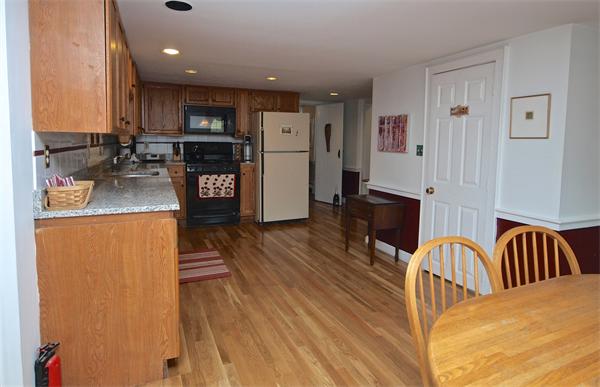 20 Farnham Circle Needham, MA 02492 - Photo 11 of 23 a kitchen with stainless steel appliances granite countertop a refrigerator a stove top oven a sink and dishwasher