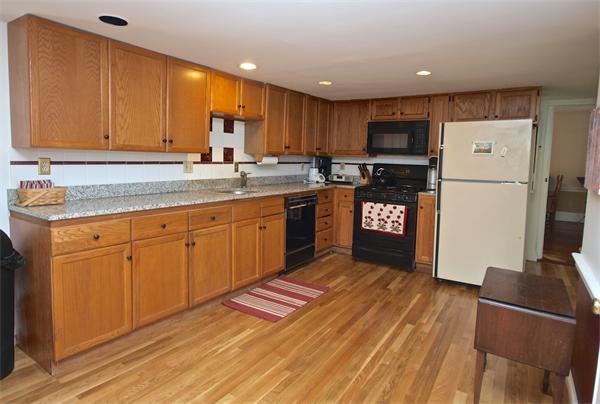 20 Farnham Circle Needham, MA 02492 - Photo 10 of 23 a kitchen with stainless steel appliances granite countertop a refrigerator sink and cabinets