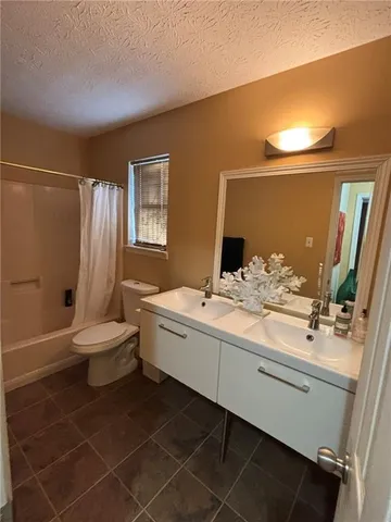 a bathroom with a sink mirror toilet and bathtub