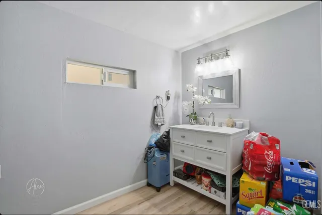 a bathroom with a sink mirror and vanity