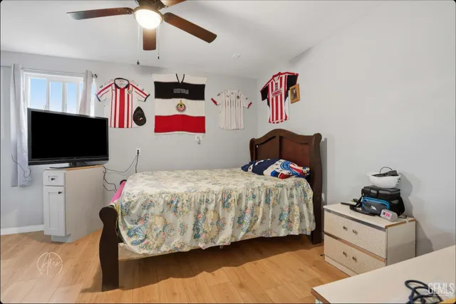 a bedroom with a bed and flat screen tv