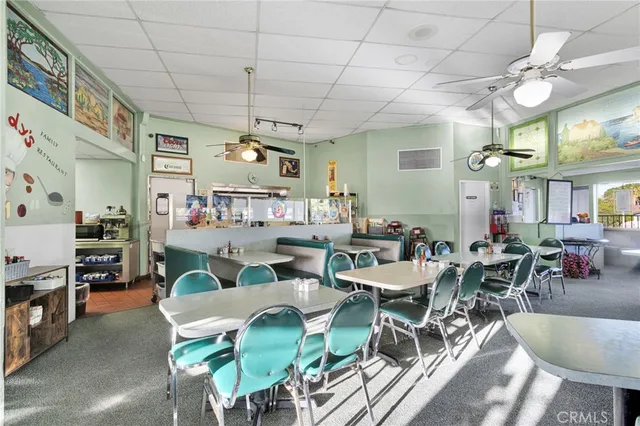 a view of a dining area with furniture window and wooden floor