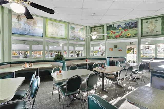 a dining room with furniture a rug and a large window