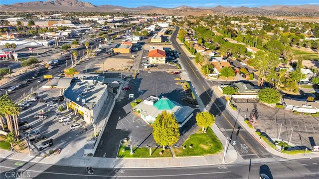 an aerial view of residential houses with yard